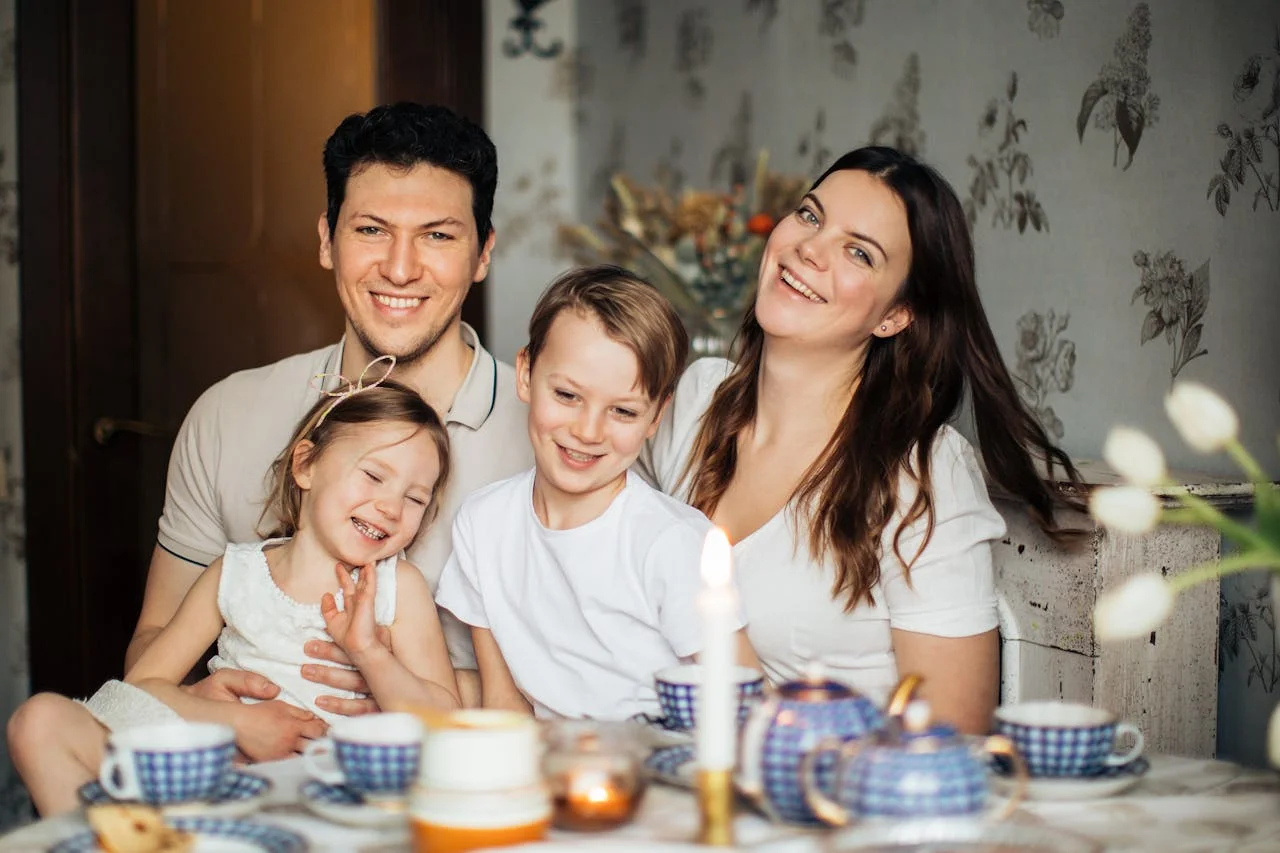 pexels-photo-3807571 Cheerful family of four enjoying a warm and cozy teatime at home, surrounded by love and laughter.